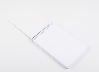 Wall Mural - Top view of notebook with blank sheets on white background. Isolated. Mockup.