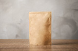 Fototapeta Lawenda - Paper bag on table. Mockup for design