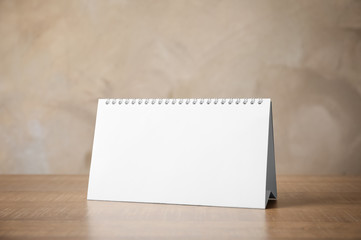 Blank desk calendar on table. Mockup for design