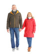 © Africa Studio - Mature couple in warm clothes walking on white background