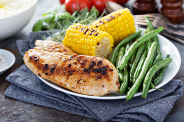 Grilled chicken with green beans in a skillet