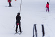A ski lift pulls a person uphill skiing
