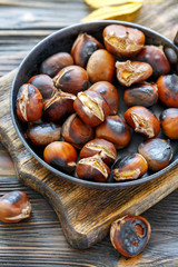 Wall Mural - Roast chestnuts in a pan closeup.