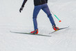Close-up of cross country skiing equipment - boots and poles on a snow background