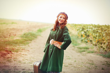 Sticker - portrait of adult girl in green coat with suitcase