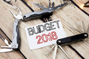 Conceptual hand writing text caption inspiration showing Budget 2018. Business concept for Household budgeting accounting planning Written on sticky note wooden background with pocket knife