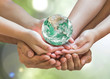 Green globe in family volunteer hands (father parent - children) for environmental protection, earth day, kindness charity donation, CSR with people concept. Elements of this image furnished by NASA