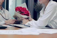 Vintage Toned Image Of Cropped Image Of Lover Giving A Bouquet Of Red Roses On Valentine's Day In Office.