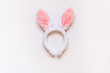 Top view of white fluffy bunny ears over white background.