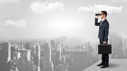 Wall Mural - man looking forward from the top of a skyscraper