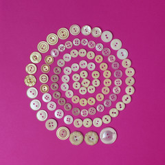 Wall Mural - Spiral from beige vintage buttons on purple background. Top view