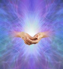 Wall Mural - Sacred Purple Ray Healing Energy - female hands  emerging from a purple energy background making cupped hands gesture with a bright light behind and plenty of copy space