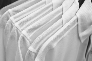 choice of polo shirts of white colors on hangers