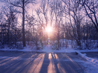 Wall Mural - Sunset on the frozen forest lake in winter.