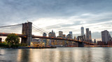 Fototapeta  - Manhattan skyline and Brooklyn Bridge view from Brooklyn Bridge Park at sunset, New York City
