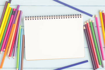 Wall Mural - blank notebook with colorful pencil on blue wooden table,top view