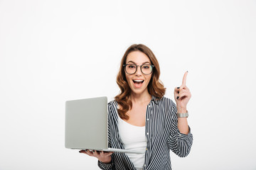 Canvas Print - Cheerful young lady using laptop computer have an idea.