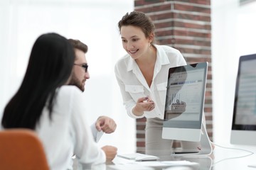 specialists of the company discussing financial schedules at the desk