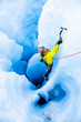 © DCrane Photography - Ice climber on rope climbing out of moulin with multiple vertical tunnels