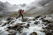 © DCrane Photography - Hiker with large pack crossing a rocky river