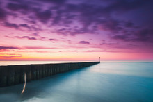 Sunset On The Beach With A Wooden Breakwater, Purple Tone