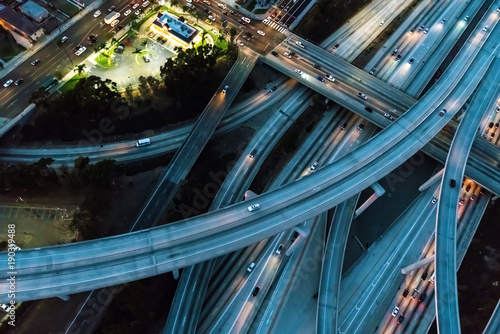 Cuadros en Lienzo Aerial view of a massive highway in Los Angeles, CA at night with young woman ho