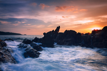 Wall Mural - Seascape of wave on rock , Long Exposure at Sunset on the beach in Phuket Thailand.