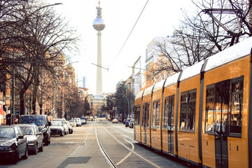 Yellow  public transportation tram passing by the city of Berlin Germany 