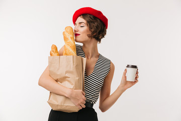 Canvas Print - Portrait of a pretty woman wearing beret smelling