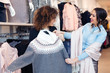 © zorandim75 - Two young girls look at clothing in store