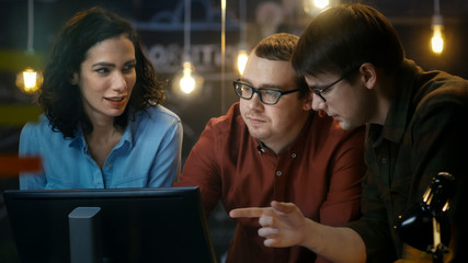 Wall Mural - three office employees have discussion about ongoing project, they point at personal computer screen