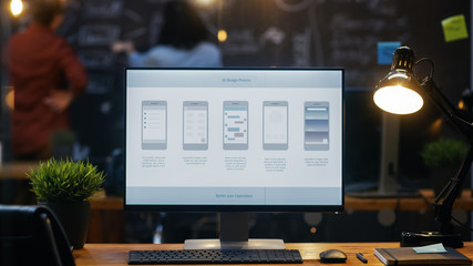 Wall Mural - personal computer with mobile application design showing on the monitor stands on the office desk, i