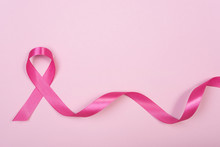 Pink Ribbon Breast Cancer On Pink Background. With Copy Space