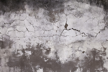 Old concrete wall with cracks. Aged cracked plaster wall background and texture style. Design on cement