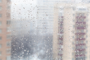 Poster - drops of melting snow on window glass in winter