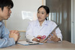 © 88studio - doctor showing test result on tablet to patient at hospital. physician talk & give advice to man about his health at medical office
