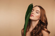 © Drobot Dean - Beauty portrait of ginger woman with long hair posing