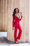 Fashion Woman in New York. Young African American Woman with long hair  dressing in red slim