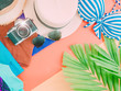 girl summer cloth accessorie with palm leaf , camera and beach hat on pastel background