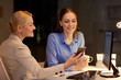 © Syda Productions - businesswomen with smartphone late at night office