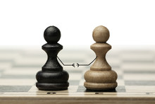 A Pair Of Enemies Reconciles And Shakes Hands At A Meeting. Made From Chess Pawns