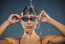 Water Splashing On Caucasian Woman Adjusting Swimming Goggles