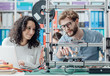 Engineering students using a 3D printer