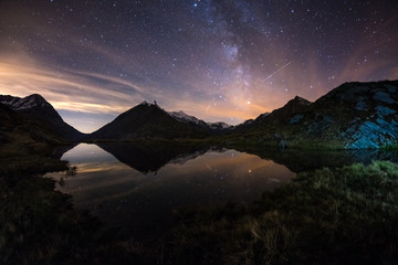 Wall Mural - milky way starry sky reflected on lake at high altitude on the alps. fisheye scenic distortion and 1