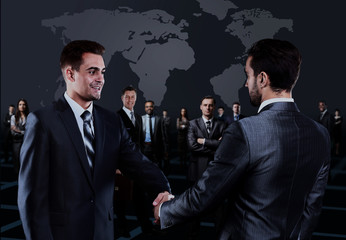 Wall Mural - Portrait of young business people. Handshake in front of business people.