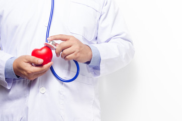 Doctor holding red heart with stethoscope on white wooden background.