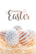 Happy easter postcard banner. Golden Easter eggs in straw nest on white background.