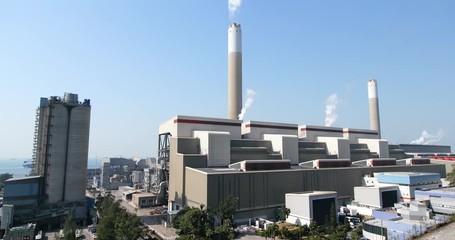 Wall Mural - Industrial factory chimney and smoke over blue sky