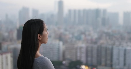 Wall Mural - Woman looking at the city view