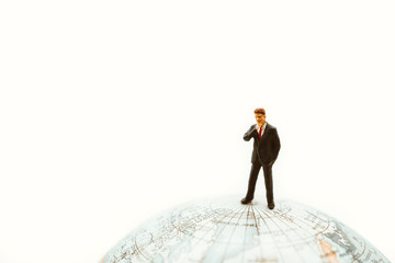 Miniature people, businessman standing on earth using as business management and global connection concept